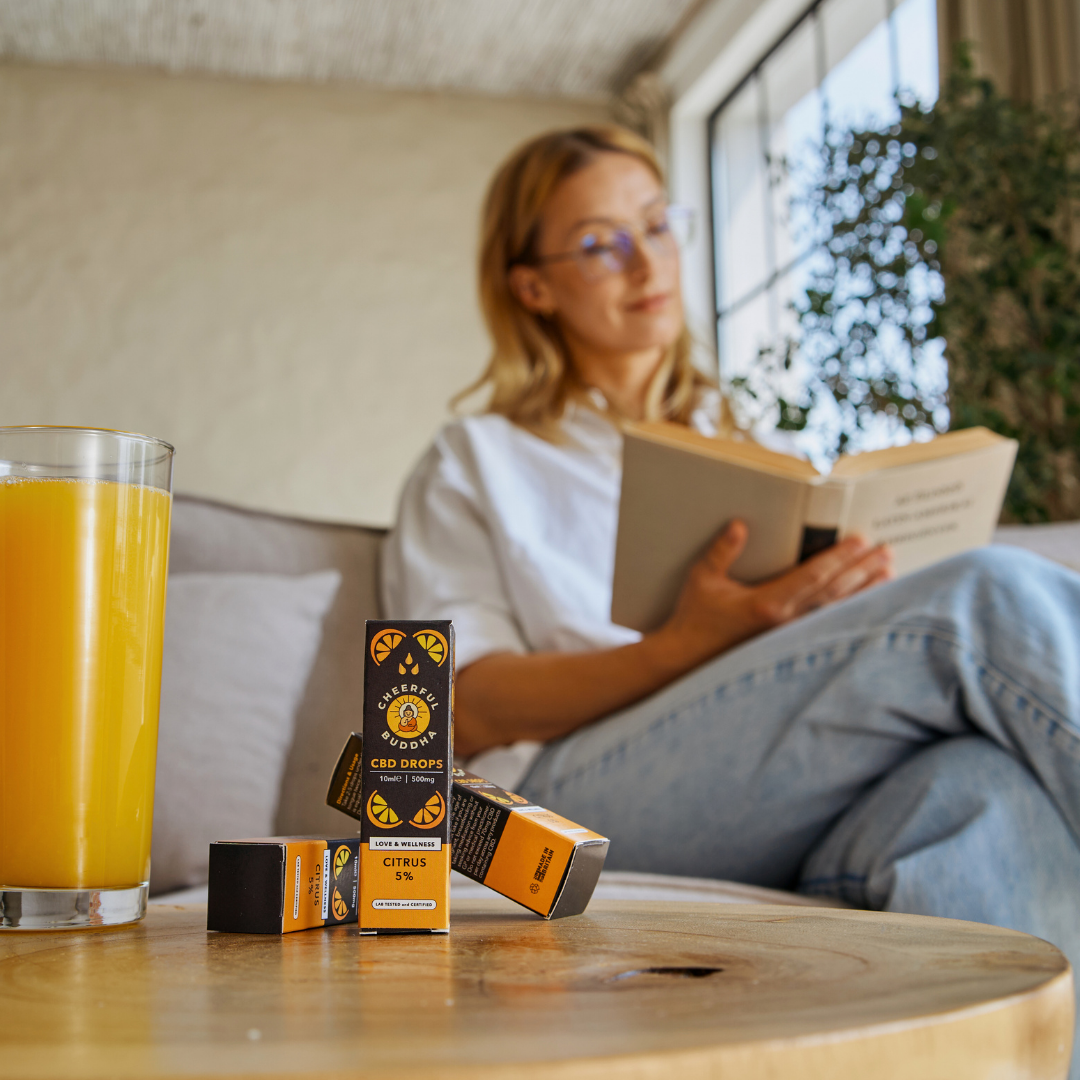 CBD drops 5% with natural orange flavour on a coffee table